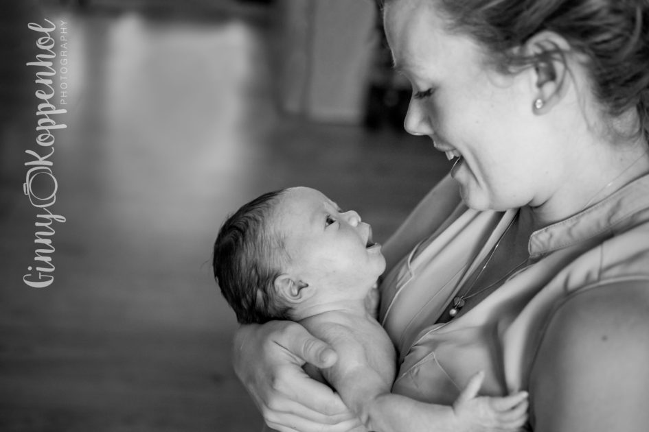 black and white photo of mother and newborn baby gazing at each other, with Ginny Koppenhol photography logo down the side