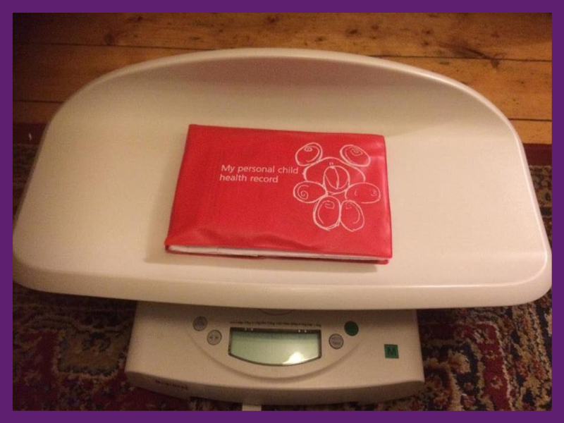 image of baby weighing scales with red book